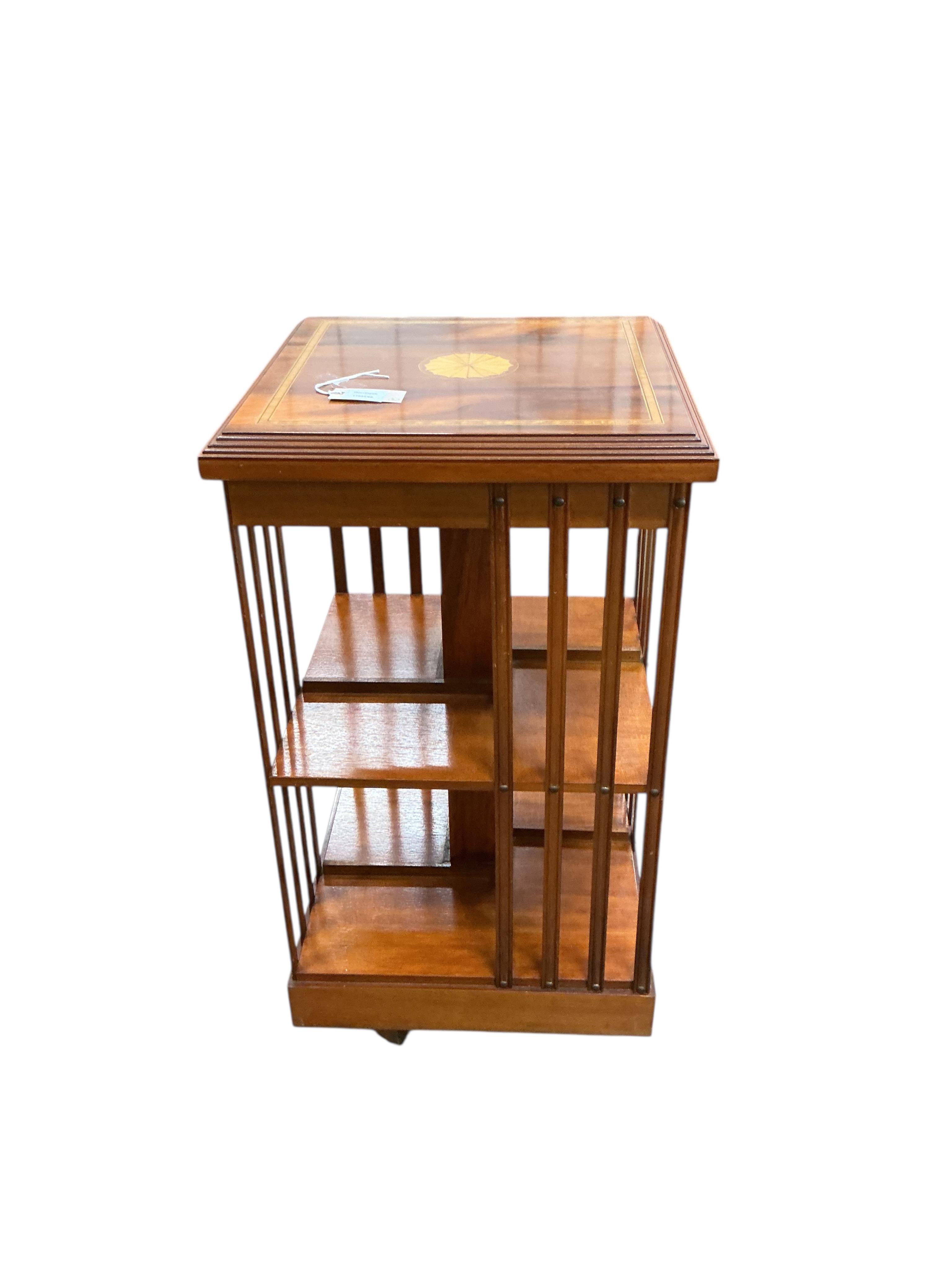 A reproduction square inlaid yew revolving bookcase, width 45cm, height 85cm, together with a reproduction Spanish style two door hardwood cabinet